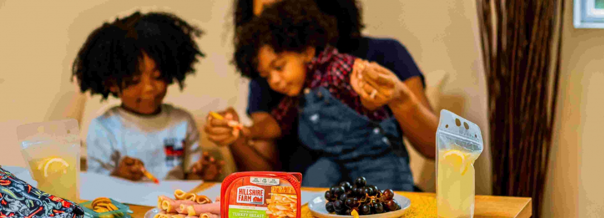 kids eating snack with their mother