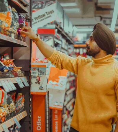 man choosing snacks at the supermarket