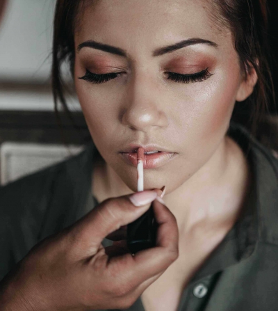 woman getting her makeup done