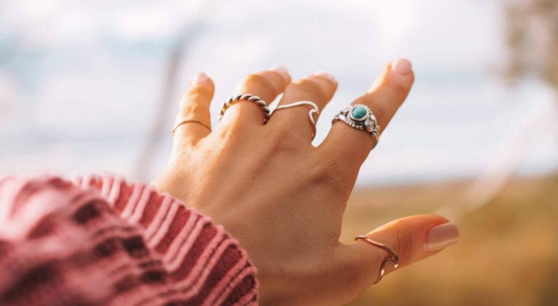 hand covered in jewelry