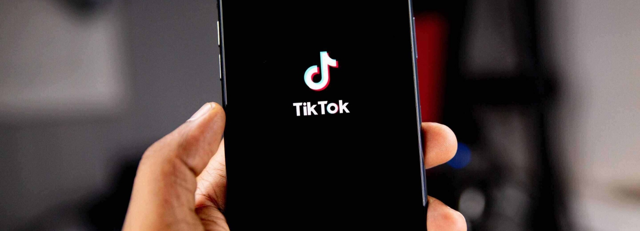 phone screen with tiktok in the background