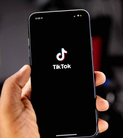 phone screen with tiktok in the background