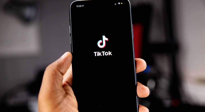 phone screen with tiktok in the background
