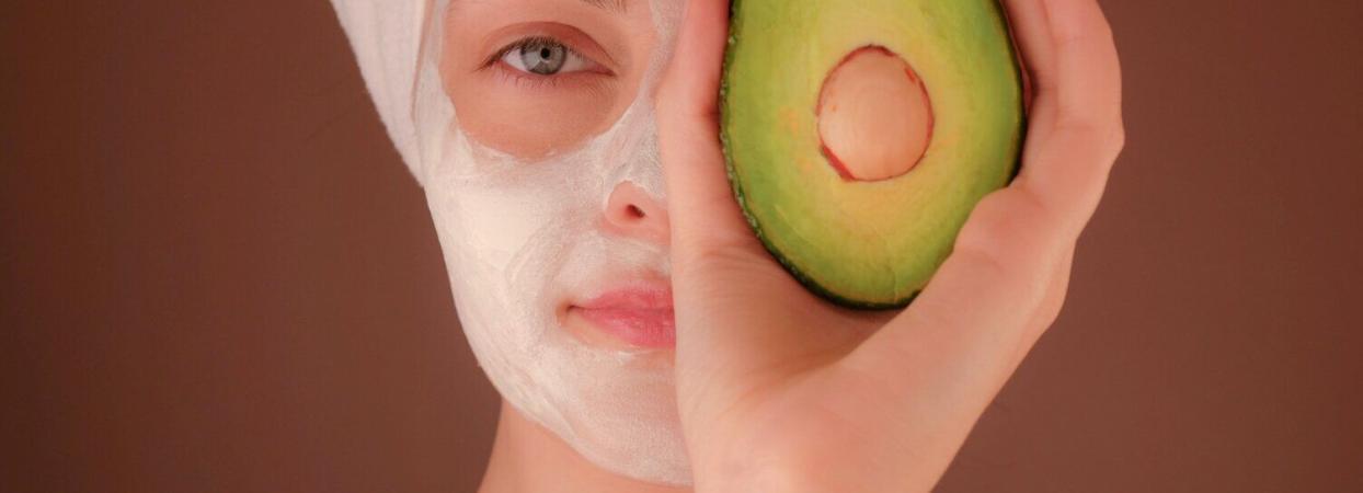 woman with skin care products on her face