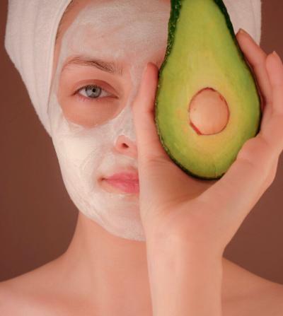 woman with skin care products on her face