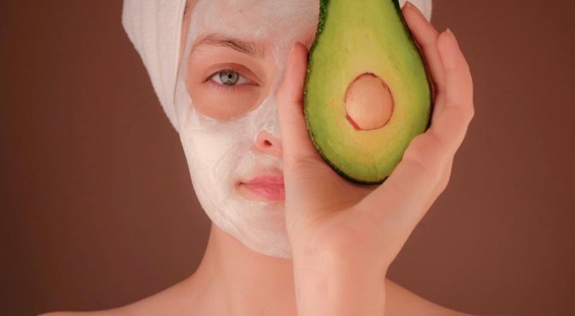 woman with skin care products on her face