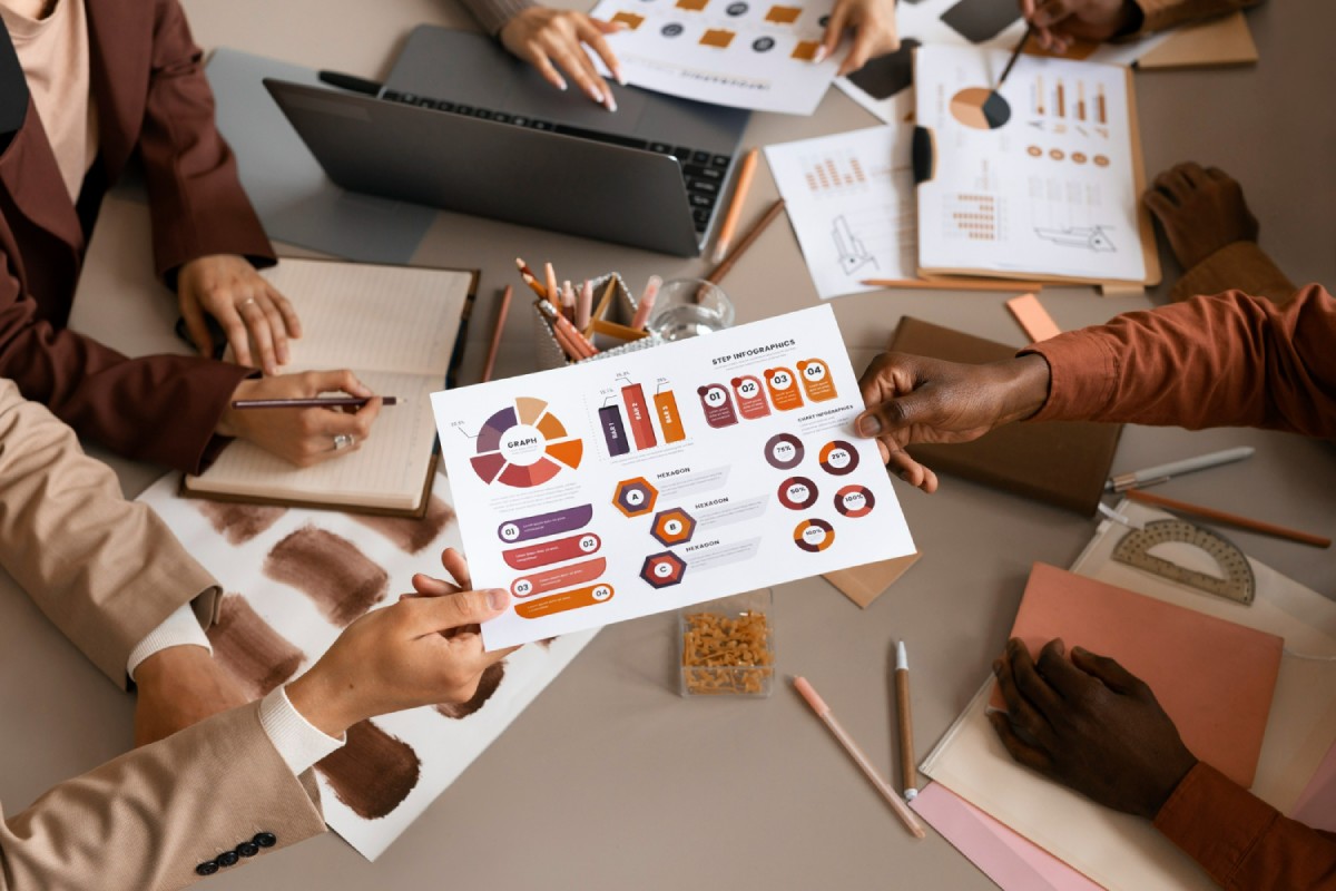 Business team analyzing data on table with graphs and documents